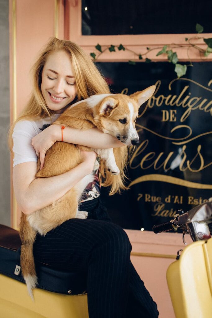 Woman Hugging Corgi